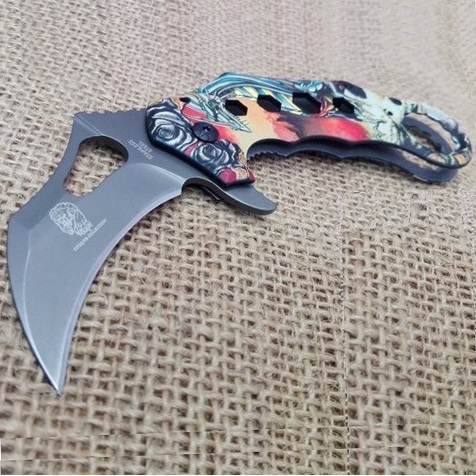 Karambit silver dragon - coltello asiatico a serramanico con lama grigia ad artiglio di tigre decorato con drago argentato.