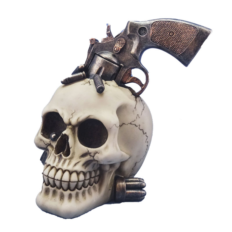 Teschio revolver da collezione - soprammobile ornamentale umoristico a forma di cranio umano decorato con pistola americana a tamburo.